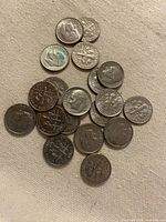 Pile of Roosevelt dimes obverse and reverse visible