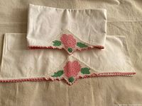 Pair of pillowcases folded to show crochet trim