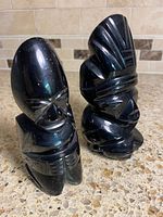 Front view both black stone figurines