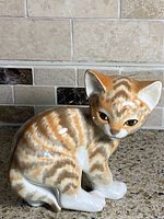 Front view of striped porcelain cat figurine