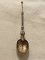 Full view of ornate sterling silver and gold washed spoon