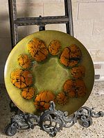 Front view of charger showing green background and orange crackle ring pattern