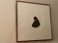 Overall view of framed artwork showing frame, mat, and circular image