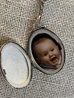 Locket open showing interior and photo