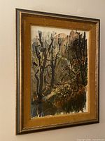 Angled view of framed watercolor painting hung on wall