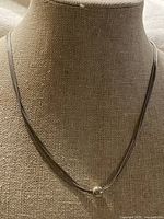 Necklace on display form showing full design and bead