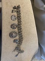 Full view of sterling charm bracelet showing chain and all charms