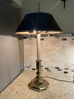 Full view of brass Bouillotte lamp on counter
