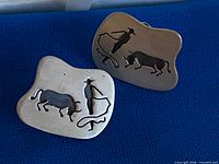 Front view of both earrings showing cowboy, bull and lasso design