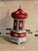 Full view of red and silver MAPSA musical carousel