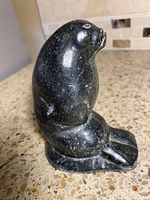 Front-left view of polished dark green soapstone seal sculpture