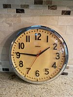 Front view of Sunbeam wall clock showing entire dial and bezel