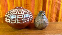 Two pottery pieces side by side on wood surface