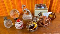 Group shot of all nine art glass items on wood surface