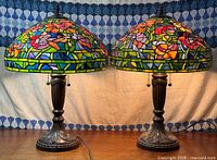 Front view of both stained glass lamps illuminated
