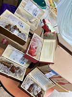 Six boxed Ellen DeGeneres ornament sets, showing contents and packaging
