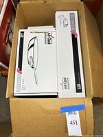 Boxed All-Clad stainless fry pan and sauté pan visible inside shipping carton