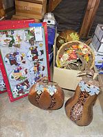 Overall lot showing boxed snowman ornaments, cardboard box with cornucopias, two large metal pumpkin lanterns