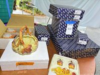 Leaf basket dish in styrofoam, stacked Fitz and Floyd boxes