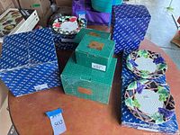 Lot overview showing boxed pieces and two grapevine plates