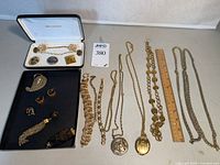 All jewelry pieces laid out with ruler for scale