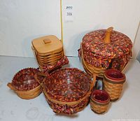 Overall group of six Longaberger baskets showing liners, protectors, pottery inserts and lidded hamper