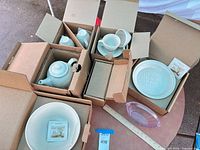 All boxed porcelain pieces and pink glass basket overview