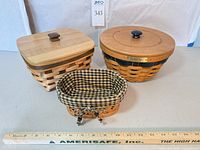 Three Longaberger baskets: round 2004 Collector's Club Ware Basket, square lidded basket, small basket with gingham liner, ruler for scale
