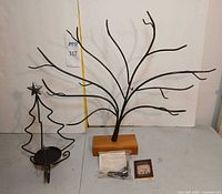 Front view of both wrought iron trees, bracket and booklet visible