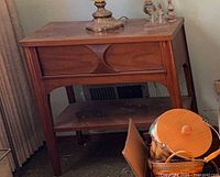 Front three-quarter view showing drawers, shelf, legs