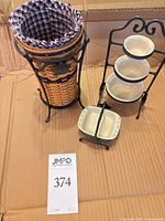 All items grouped: tiered stand with bowls, umbrella basket in stand, casserole baker in cradle