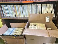 Shelf with two rows of uniform white-spine National Geographic hardcovers