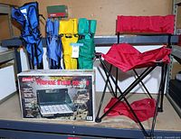 Group shot showing boxed Coleman stove and all five folding camp chairs