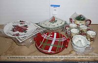 Group shot of all ceramic pieces including lidded casserole, teapot set, mugs, baker and Bundt mold