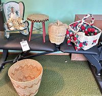 Full lot showing rocking chair, side table, two wicker baskets and wastebasket
