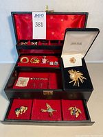 Overall view of jewelry box open displaying jewelry pieces