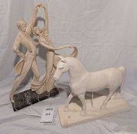 Overall view of both sculptures—A. Santini dancers on granite base alongside white painted wooden horse