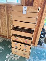 Stack of nine cardboard ornament storage drawers