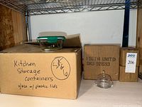 Closed carton labeled kitchen storage containers S/6 glass w/ plastic lids; additional carton marked 1 set (4 units); single butter dish displayed