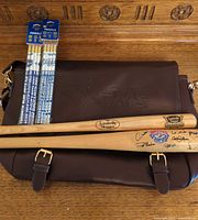 Bag front with embossed Star Wars logo, both mini bats across flap, two sealed pencil packs on top