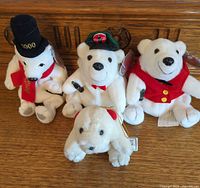 Group of four Coca-Cola polar bear plush toys