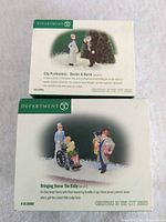 Front of both Department 56 figurine set boxes