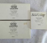 front of three boxes showing series names and set titles