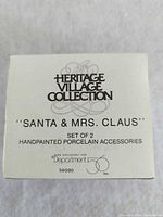 Box top showing Heritage Village Collection Santa & Mrs. Claus set information