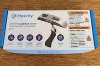 Front of retail box showing Etekcity EL11 digital luggage scale image and specifications