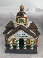 Front of porcelain Village Bank & Trust building showing striped columns and dome