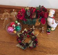 All items grouped: floral sleigh, goose planter, wire angel topper, candle, berry wreath, glass bowl with ornaments, soldier ornament, metal angels