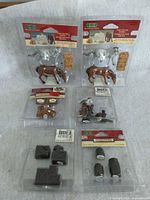 Overview of the six Lemax blister packs showing horses, harbor accessories, crates and barrels