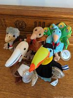 Group shot of five Coca-Cola mini plush tropical birds