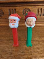 Front view of both PEZ dispensers showing character heads and stem colors